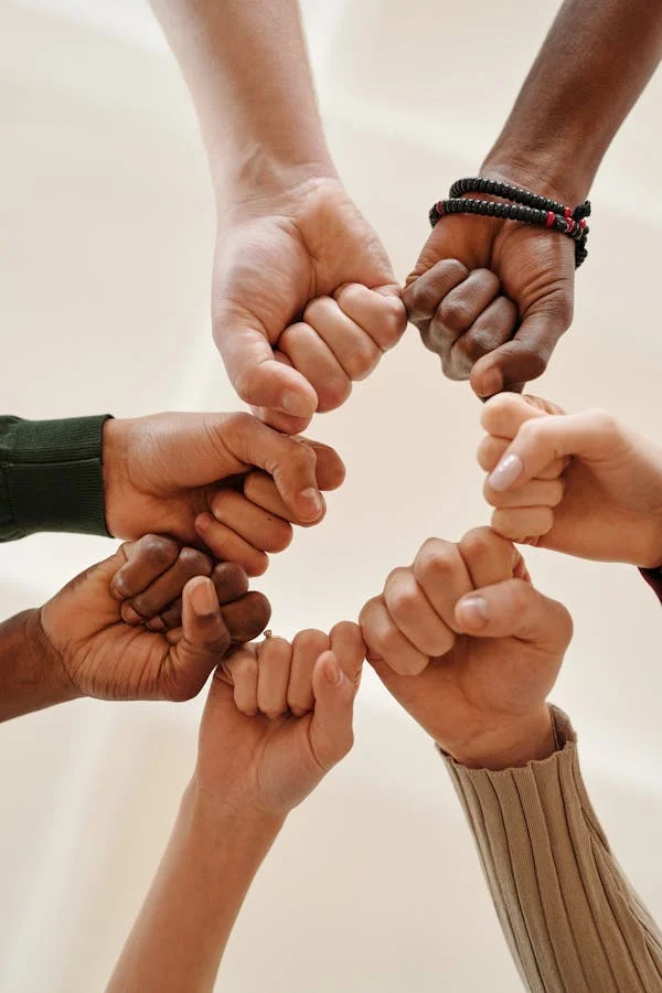 diverse hands forming a circle with fists psychiatric care