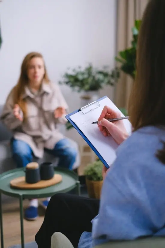 psychiatrist filling out forms with patient